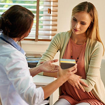 A doctor discusses vaginal yeast infection treatments with a patient.