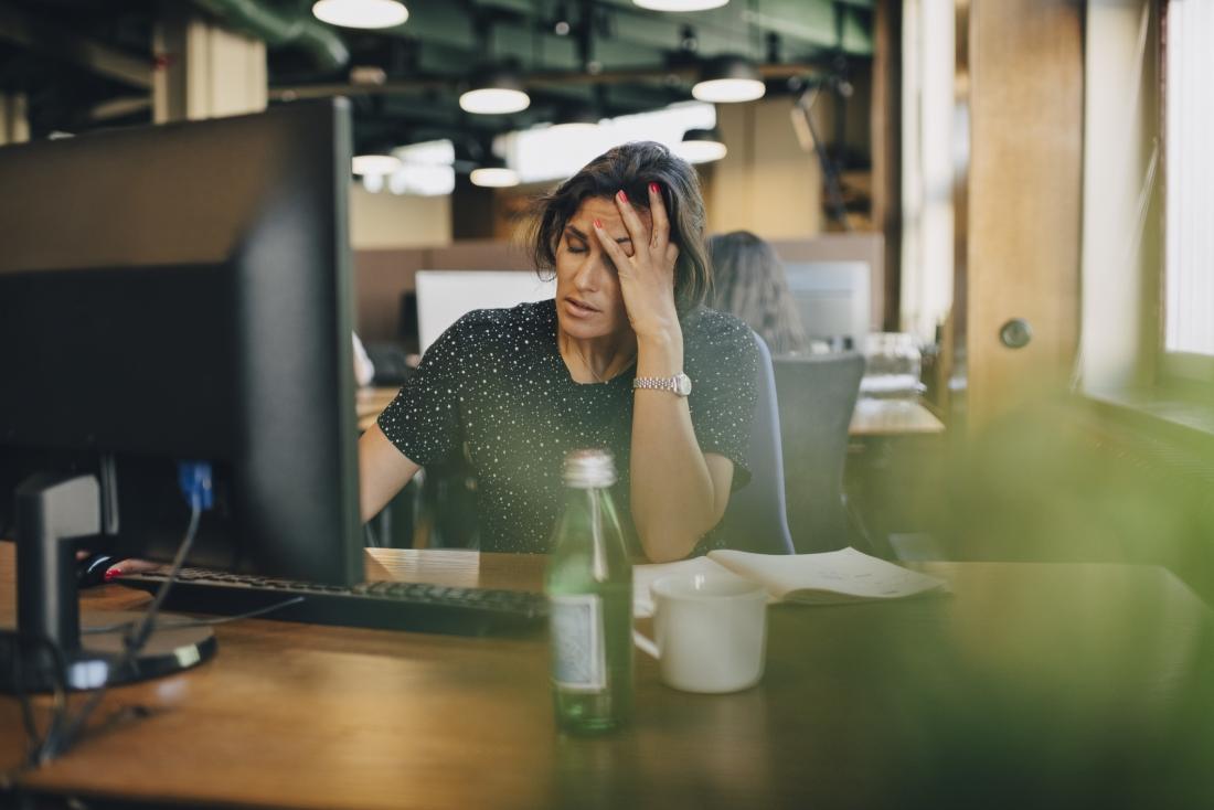 person feeling stressed and overwhelmed at work