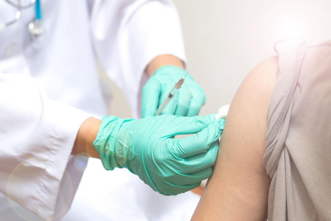 close up of doctor administering flu shot