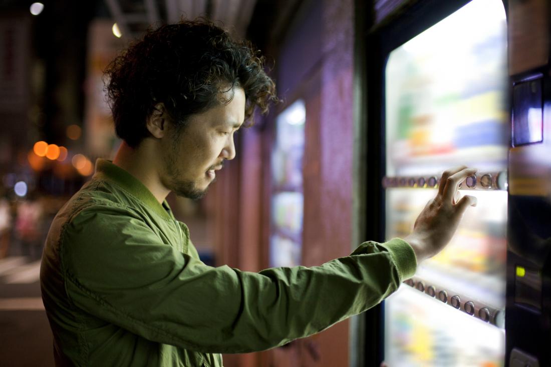 man staring at vending machine