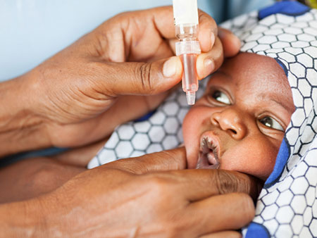 Picture of a child receiving the oral polio vaccine