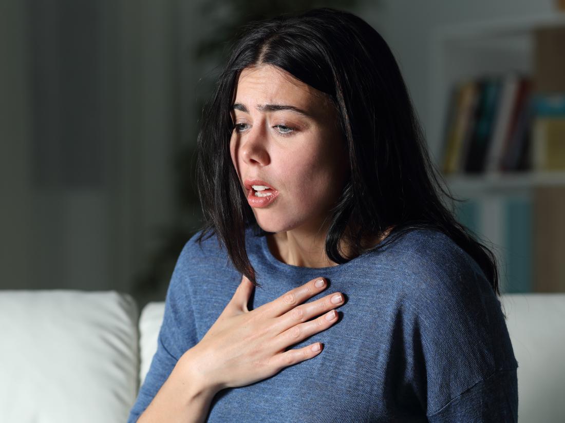 a woman experiencing shortness of breath because of anxiety