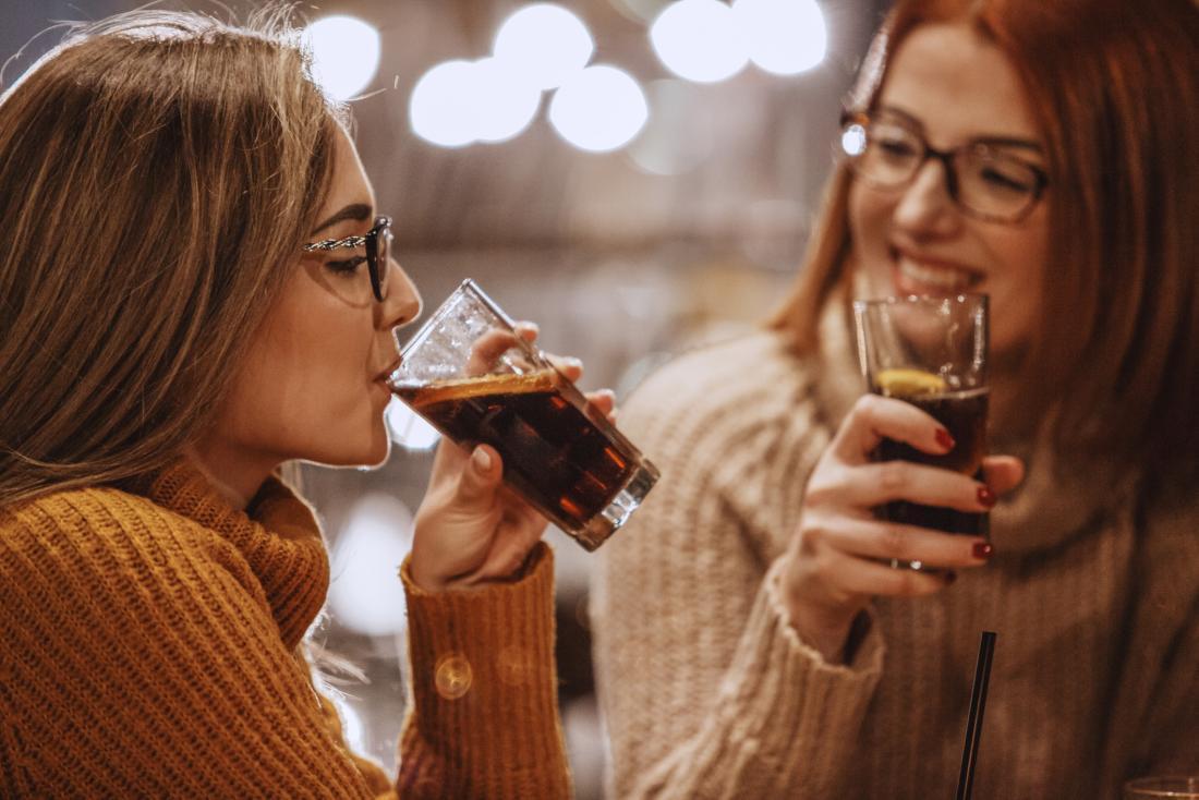Women sharing soda
