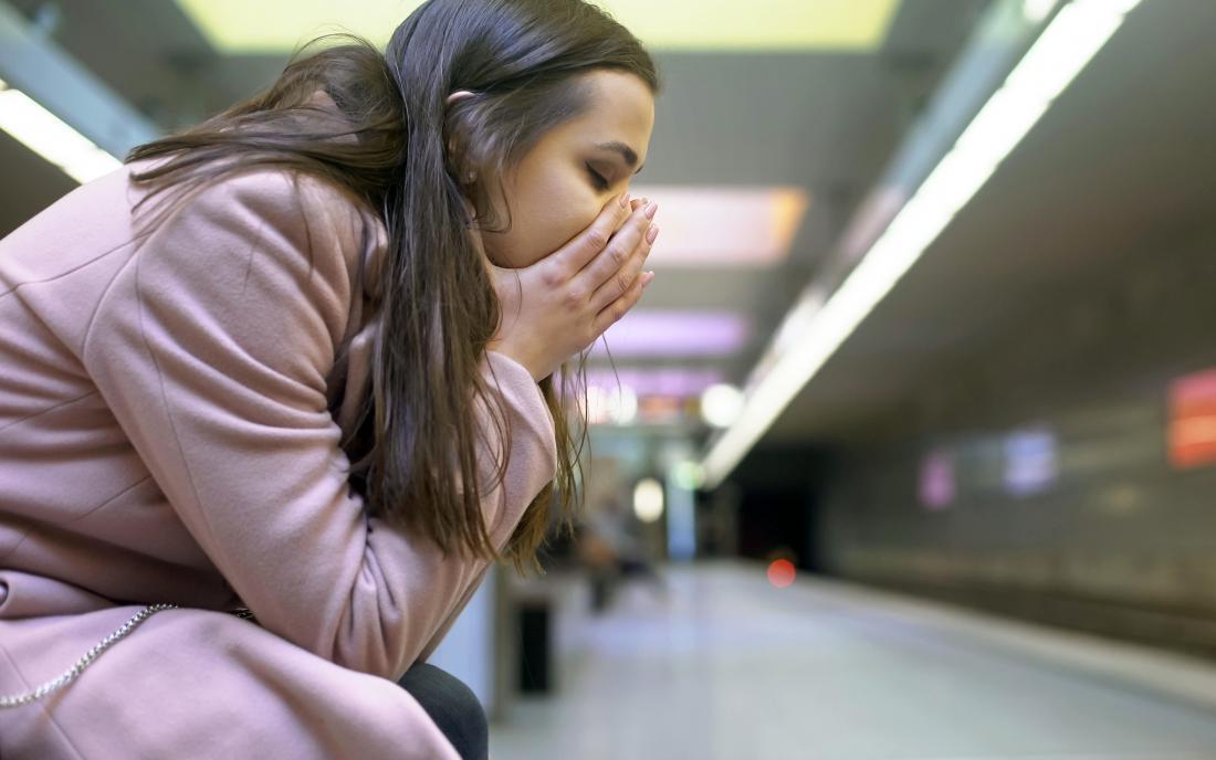 a woman experiencing shock at a subway station.