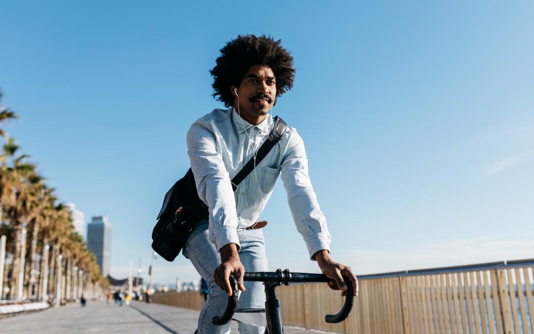 a man enjoying the benefits of aerobic exercise through cycling. 