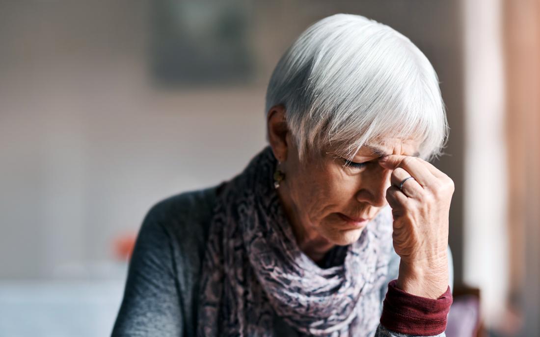 a woman experiencing a headache because of Metabolic acidosis