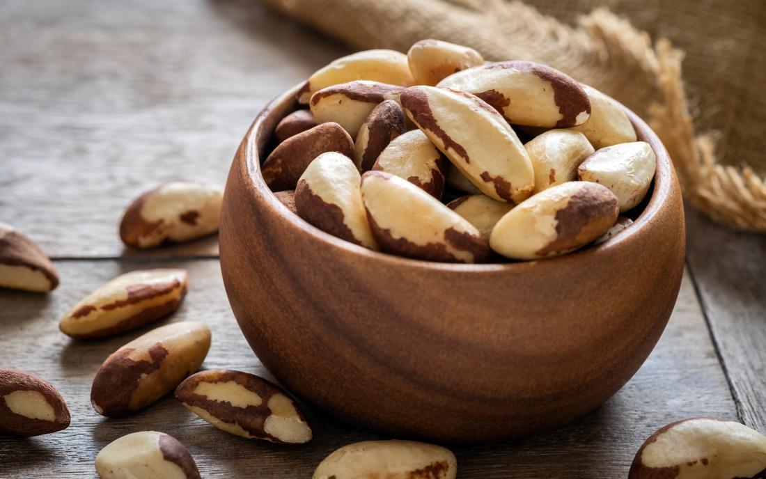 Brazil nuts in wooden bowl which may cause an allergy 