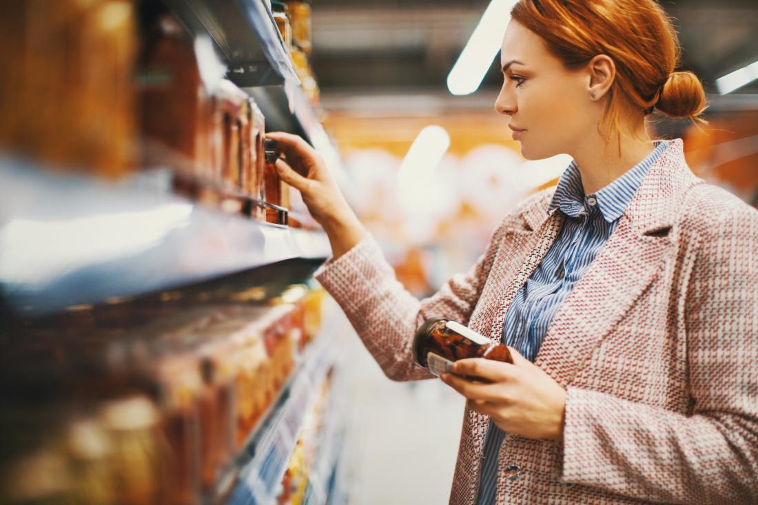 woman choosing foods off a shelf