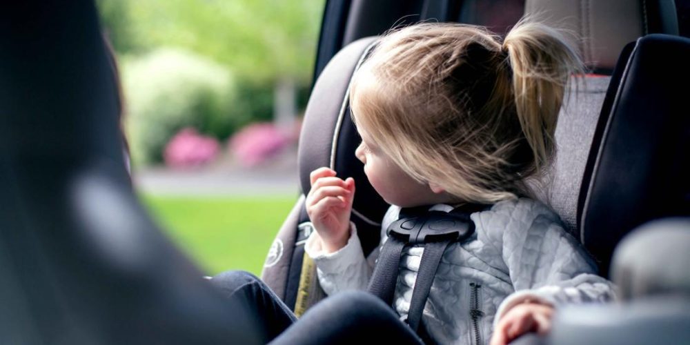 When can a child sit in the front seat of a car?