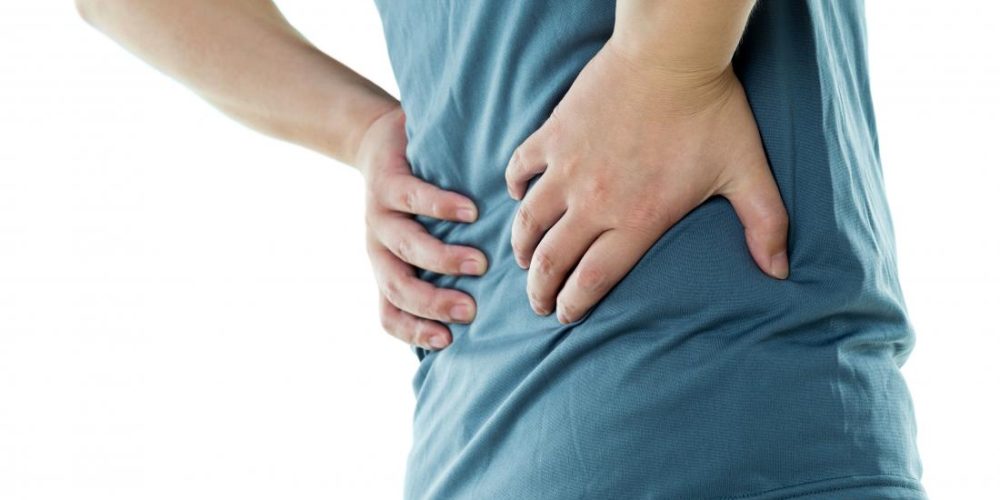 How does psoriatic arthritis affect the spine?