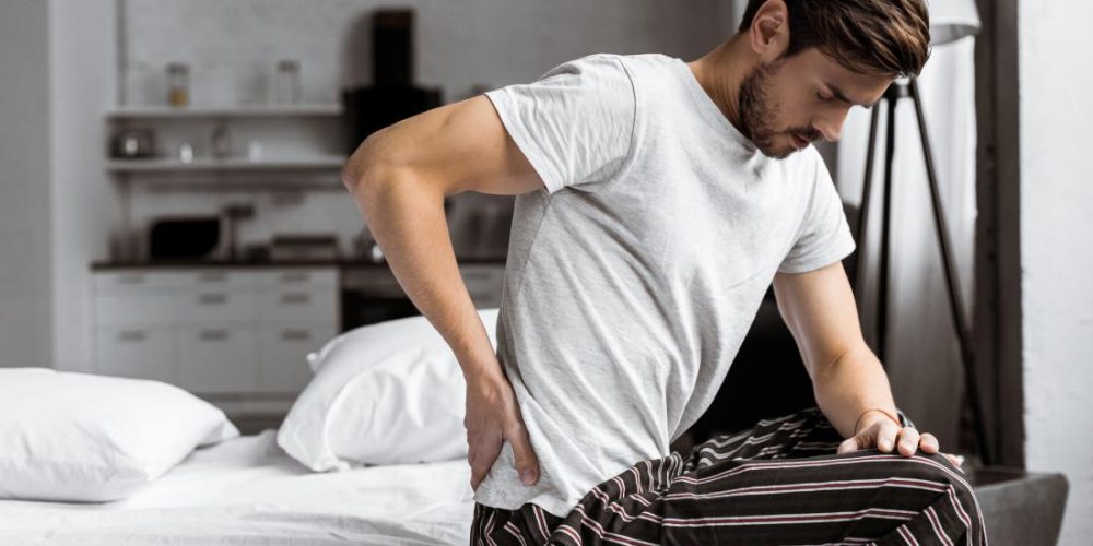 What can cause lower back and testicle pain?